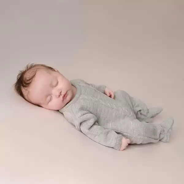 Grey cable knitted newborn onesie Spilsby